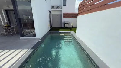 a swimming pool in the middle of a house at Oceanview Villa With King Beds in Las Terrenas