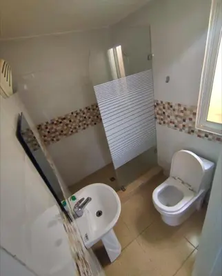 a small bathroom with a toilet and a sink at Cruce Caribeña in Boca Chica