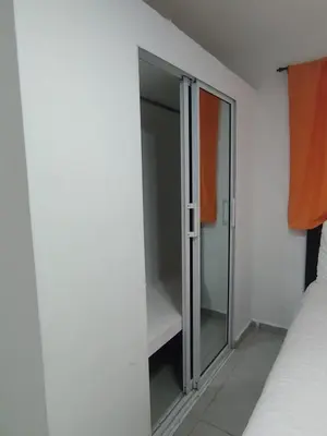 a bedroom with a sliding glass door and a closet at Cruce Caribeña in Boca Chica