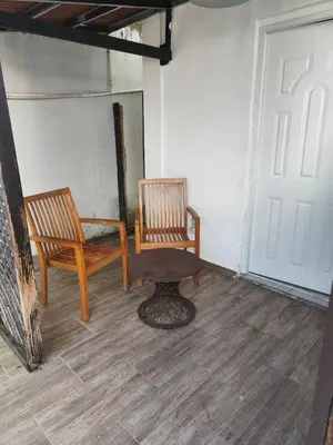 a room with two chairs and a table and a door at Cruce Caribeña in Boca Chica