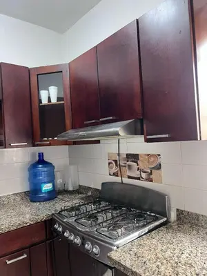 a kitchen with a stove top oven in a kitchen at Casa amueblada en San Cristóbal in San Cristóbal