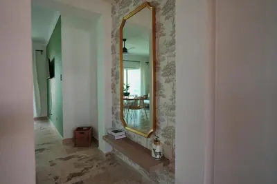 a mirror on a wall in a room at Tropical Gem by the Sea in Sosúa