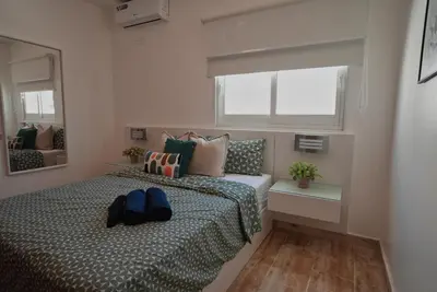 a bedroom with a bed and a mirror at Tropical Gem by the Sea in Sosúa
