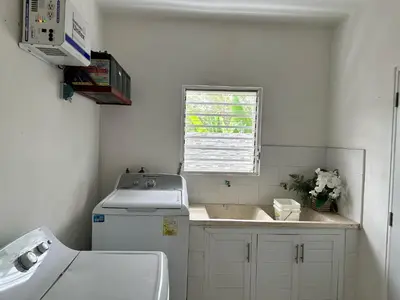 a small white kitchen with a sink and a window at Casa en la Autopista de San Isidro in Hainamosa