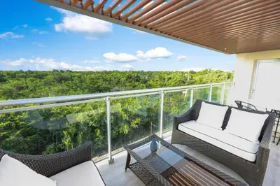 a balcony with wicker chairs and a glass table at 504 New, Fantastic Rooftop with Private Jacuzzi in La Laguna