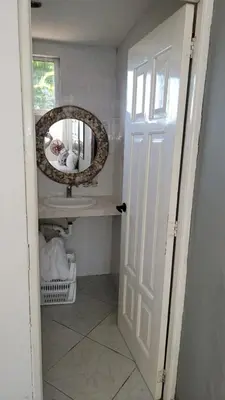 a bathroom with a mirror and a sink at Hotel Appartements Hummingbird CABARETE in Cabarete