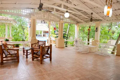 a large room with chairs and tables and windows at Rancho Juliana in Villas del Mar