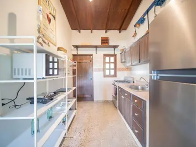 a kitchen with a sink and a refrigerator at 2BR Colonial Penthouse in Sosua next to BEACH in Sosúa