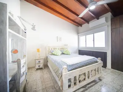 a bedroom with a wooden bed and a window at 2BR Colonial Penthouse in Sosua next to BEACH in Sosúa