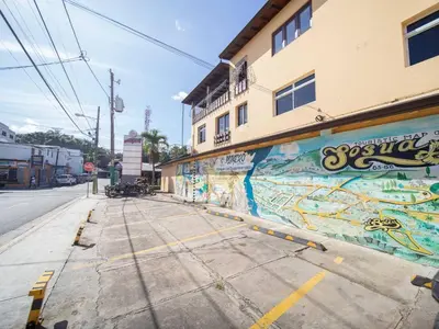 an empty street with graffiti on the side of a building at Colonial 2BR Apartment 2mins walk to beach in Sosúa