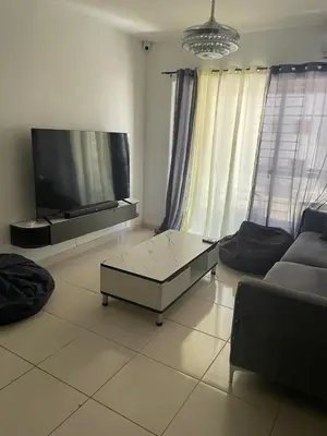 a living room with a large flat screen tv at Apartamento en ciudad Juan bosch con todas las amenidades in Los Paredones