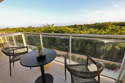 a patio with a table and chairs on a balcony at 404-C Luxurious Apartment 5 Minutes from the Beach in La Laguna