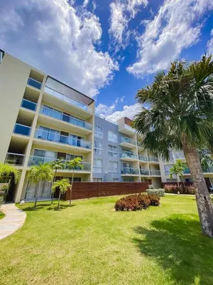 a large apartment building with palm trees in the yard at 404-C Luxurious Apartment 5 Minutes from the Beach in La Laguna