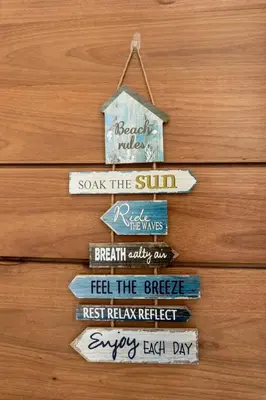 a group of signs hanging on a wooden wall at Caribey2 APT 3D1 in Las Terrenas