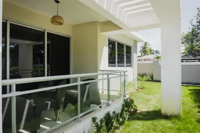 a balcony of a house with a view of the yard at Caribey2 APT 3D1 in Las Terrenas