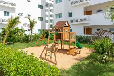 a playground in a yard in front of a building at Beach Escape -Pool Patio -Free Parking -Pets in Villas del Mar