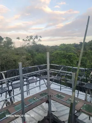 a group of benches sitting on top of a wooden deck at Rancho Salto Yanigua in El Valle