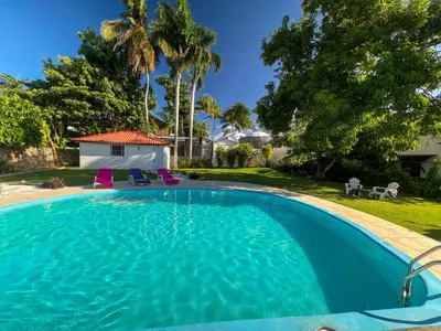 a swimming pool in the backyard of a house at Mango house bliss in Las Galeras