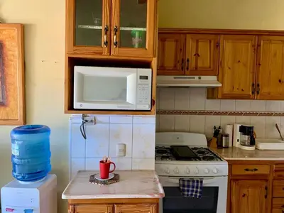 a kitchen with a stove and a microwave at Condo Sosúa in Sosúa