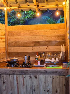 a counter with a stove in a wooden cabin at Pure Nature - Eco-lodge in the Mountains! in La Búcara