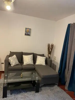 a living room with a couch and a table at Kasita del sol boca chica in Boca Chica