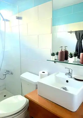 a white bathroom with a sink and a toilet at Modern Apartment, Juan Dolio Beach, BlueSea Tower in Villas del Mar