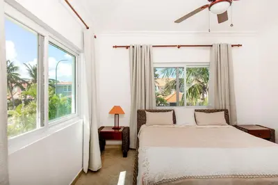 a bedroom with a bed and a large window at Stunning 4 BR Luxury Villa in Punta Cana