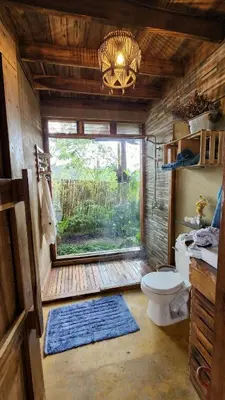 a small bathroom with a toilet and a window at MaRaVillas DR in the mountains excellent location in Jarabacoa