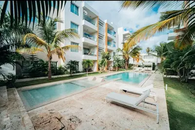 a swimming pool in front of a building at Apartamento en punta cana close to the beach in Punta Cana