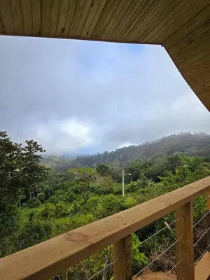 a view of a mountain from a wooden balcony at Mountain refuge - Cabin with wonderful views! in La Búcara