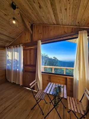 a room with a table and chairs and a large window at Mountain refuge - Cabin with wonderful views! in La Búcara