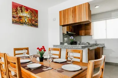 a kitchen and dining room with a wooden table and chairs at Caribey2 APT 2D2 in Colorado