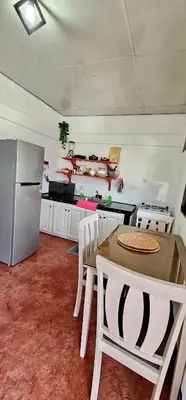 a kitchen with a table and a stainless steel refrigerator at Apartamento Mirador de La ciudad in Jarabacoa