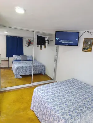 a room with two beds and a flat screen tv at Apart hotel Costa Verde#7 con cama Queen in Las Galeras