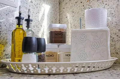 a basket with bottles of alcohol and toiletries on a counter at Elegant Centric Apt Near all in Santo Domingo