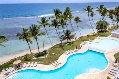 an aerial view of the beach and swimming pool at the resort at Cozy Beach Condo Great Views in Guayacanes
