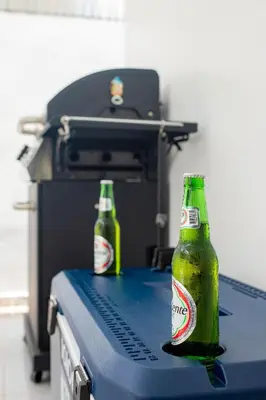 two bottles of beer sitting on top of a machine at Sol, playa y arena, Casa cerca de la playa in San Felipe de Puerto Plata