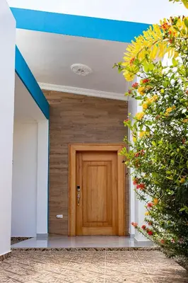 a wooden door in the middle of a building at Sol, playa y arena, Casa cerca de la playa in San Felipe de Puerto Plata