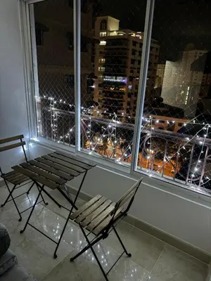 a bench and a chair in front of a window at Torre DOÑA EVA in Santo Domingo