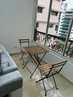 a living room with a table and a couch at Torre DOÑA EVA in Santo Domingo