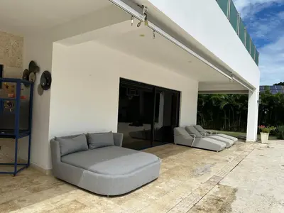 a living room with two couches on a patio at Villa paraíso in Juan Dolio