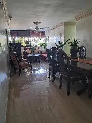 a living room with a couch and a table and chairs at Veronica in Santo Domingo