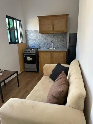 a living room with a couch and a kitchen at Residencial Fe y Esperanza in Pedernales
