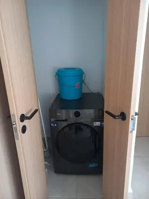 a black microwave in a room with a bucket on top of it at Apartamento en Vista Cana in Batey San Germán