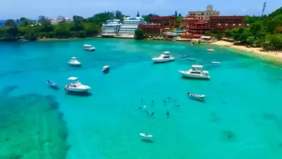 a group of boats in the water near a beach at Central, a 5 Minutos de Playa, AC, Piscina, Cómodo, Bares, Rest in Sosúa
