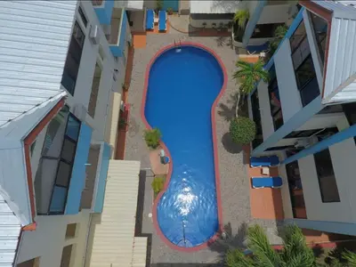 an overhead view of a swimming pool between two buildings at Central, a 5 Minutos de Playa, AC, Piscina, Cómodo, Bares, Rest in Sosúa