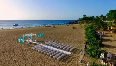 a group of white chairs on a beach at Central, a 5 Minutos de Playa, AC, Piscina, Cómodo, Bares, Rest in Sosúa