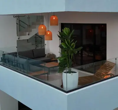a living room with a glass table and a potted plant at Terraza Caribeña in Bayahibe