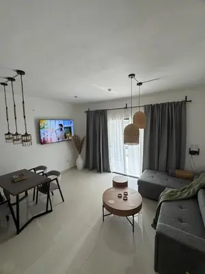 a living room with a couch and a table at Terraza Caribeña in Bayahibe