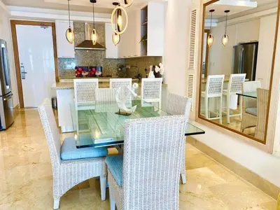 a dining room with a glass table and wicker chairs at Fortunity1 Escape, Puerto plata Playa Dorada in San Felipe de Puerto Plata